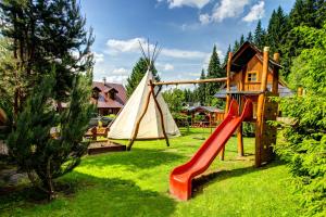 a playground with a slide and a teepee at Pinius by Hotel Pieris in Pribylina