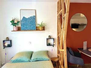 a bedroom with a bed and a mirror at Suite Sunset in Saint Malo