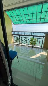 a room with a blue chair and a glass floor at PD Grand SEAVIEW in Port Dickson