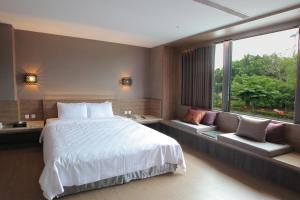 Ένα ή περισσότερα κρεβάτια σε δωμάτιο στο Imperial Dynasty Boutique Hotel