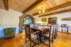 a dining room with a wooden table and chairs at Dom Szklarski Kamień in Szklarska Poręba