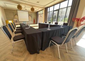 a conference room with a long table and chairs at SUMAHAN SUITES & SPA in Marrakesh +104 photos