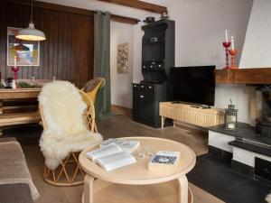 a living room with a table and a tv at Apartment Entremont 60 by Interhome in Verbier