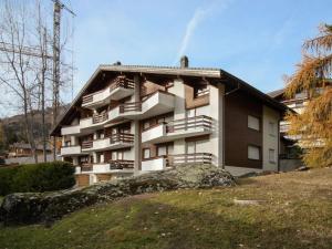 a building with balconies on the side of it at Apartment Entremont 60 by Interhome in Verbier