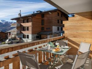 a patio with a table and chairs on a balcony at Apartment Stem 2 by Interhome in Verbier