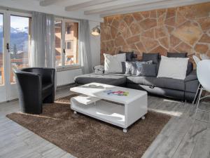 a living room with a couch and a table at Apartment Stem 2 by Interhome in Verbier