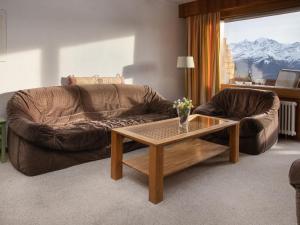 a living room with a couch and a coffee table at Apartment Porthos 37 by Interhome in Verbier
