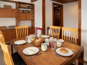 a wooden table with eggs and bread on it at Apartment Porthos 37 by Interhome in Verbier