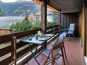 a table and chairs on the balcony of a cabin at Apartment Centaure B RS 2 by Interhome in Ovronnaz