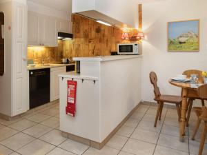 a kitchen and dining room with a table and chairs at Apartment Centaure B RS 2 by Interhome in Ovronnaz +20 photos