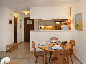 a kitchen and dining room with a table and chairs at Apartment Centaure B RS 2 by Interhome in Ovronnaz