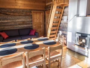 a dining room with a table and a fireplace at Holiday Home Putilanranta by Interhome in Saapunki
