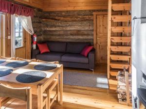 a living room with a couch and a table at Holiday Home Putilanranta by Interhome in Saapunki