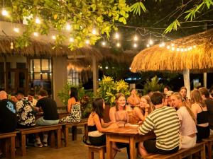 a group of people sitting at tables in a restaurant at Rupas Hotel in Arugam Bay