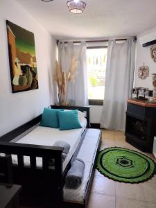 a living room with a couch and a window at Casita Tafí del Valle in Tafí del Valle