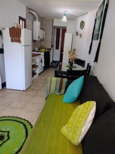 a living room with a couch and a kitchen at Casita Tafí del Valle in Tafí del Valle +16 photos