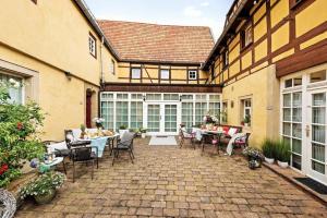 a patio with tables and chairs in a building at Landhaus Sofie in Kreischa