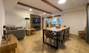 a dining room and living room with a table and chairs at Chalet Green Park in Stará Lesná