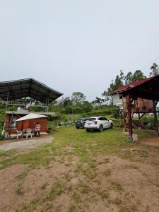 a car parked in a yard next to a building at Cabaña BellaVista in Oxapampa