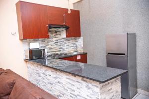 a kitchen with a counter and a refrigerator at Falcon Lodge PK in Bela-Bela