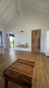 a room with a wooden floor and a wooden table at Lakay zot in Le Vauclin