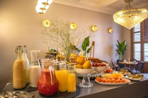 a breakfast table with fruits and vegetables and juice at Hotel Casa Bianca by Faranda Boutique in Cartagena de Indias