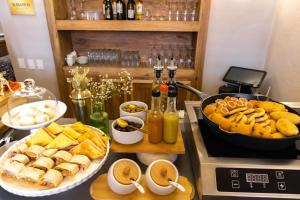 a table with a bunch of food on a stove at Hotel Casa Bianca by Faranda Boutique in Cartagena de Indias