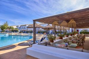 a resort with a swimming pool with chairs and a swimming pool at Seaclub Alcudia in Port d'Alcudia