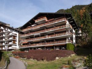 a large apartment building on a hill next to a road at Apartment Parc B 431 by Interhome in Champex