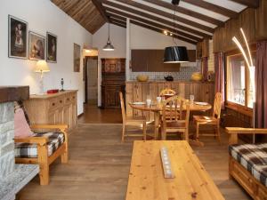 a kitchen and dining room with a table and chairs at Apartment Parc B 431 by Interhome in Champex