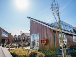 a building with a red heart on the side of it at Holiday Home Kraaijennest by Interhome in Uitgeest