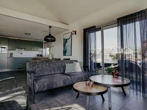 a living room with a couch and a table at Holiday Home Kraaijennest by Interhome in Uitgeest +31 photos