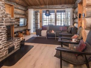 a living room with a couch and a fireplace at Holiday Home Harjula by Interhome in Nissi