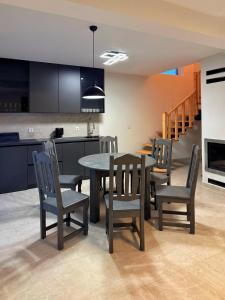 a kitchen and dining room with a table and chairs at Yaremche Soul House in Yaremche +10 photos