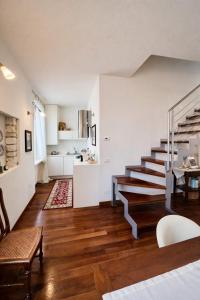 a living room with a staircase and a kitchen at La Suite del Centro in Lazise +7 photos