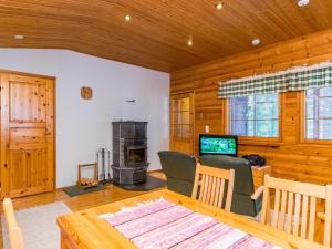 a living room with a table and a fireplace at Holiday Home Ruskatupa by Interhome in Ruka