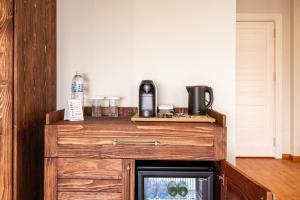 a kitchen with a wooden counter top with a microwave at Ephesus Select Suites in Kuşadası