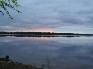 a large body of water with the sunset in the background at Holiday Home Rantapuro by Interhome in Joutsenniemi