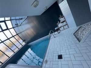 a bathroom with a swimming pool in a room at Sure Hotel by Best Western Argentan in Argentan