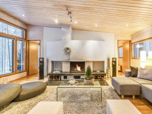 a living room with a couch and a fireplace at Holiday Home Koukunmaja by Interhome in Kuusamo