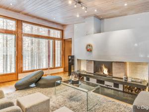 a living room with a fireplace and a couch at Holiday Home Koukunmaja by Interhome in Kuusamo