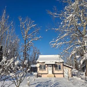 a small house with snow on top of it at Drinska Ljepotica in Bijeljina