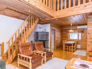 a living room with a staircase and a fireplace at Holiday Home Revontuli by Interhome in Ruka