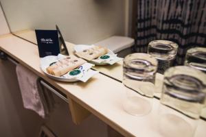 a table with some food and glasses on it at Villa del Rio Express in Valdivia +2 photos
