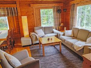 a living room with couches and a coffee table at Holiday Home Joutilas by Interhome in Ruka