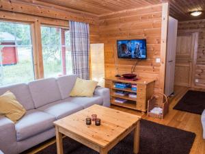 a living room with a couch and a coffee table at Holiday Home Joutilas by Interhome in Ruka