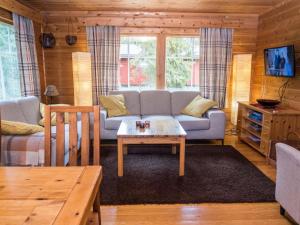 a living room with a couch and a coffee table at Holiday Home Joutilas by Interhome in Ruka