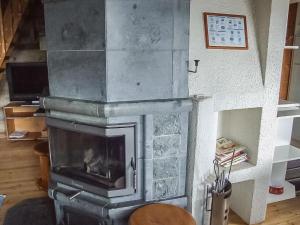 a stone fireplace in a living room with at Holiday Home Honkapirtti- vuotunki by Interhome in Kunnari