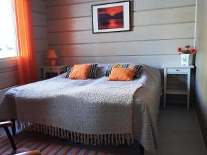 a bedroom with a bed with two pillows on it at Holiday Home Loisteranta by Interhome in Vääräkoski +19 photos