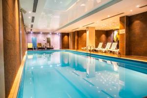 a large swimming pool in a hotel room at Orbi Palace Delux A in Bakuriani